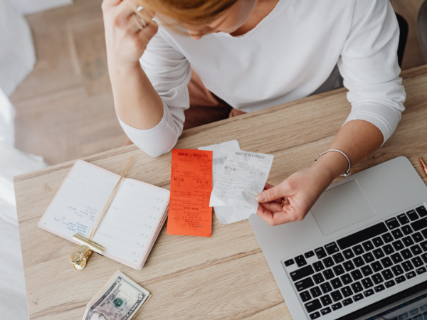 Woman stressing out about bills which are now higher due to inflation.